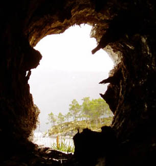 headland on lake Reinsjøen taken looking through a hollow log on the shore