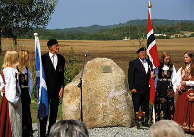 The memorial stone and flag bearers